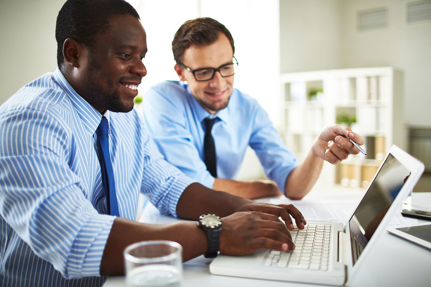 Two business-people using a laptop in an office
