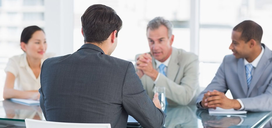 Businessman leads business meeting with other managers in board room 2