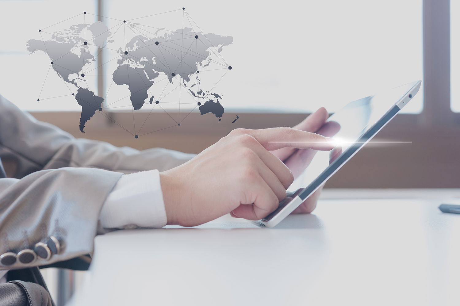 Businessman finger touching touch-pad with with an abstract connected world map design background